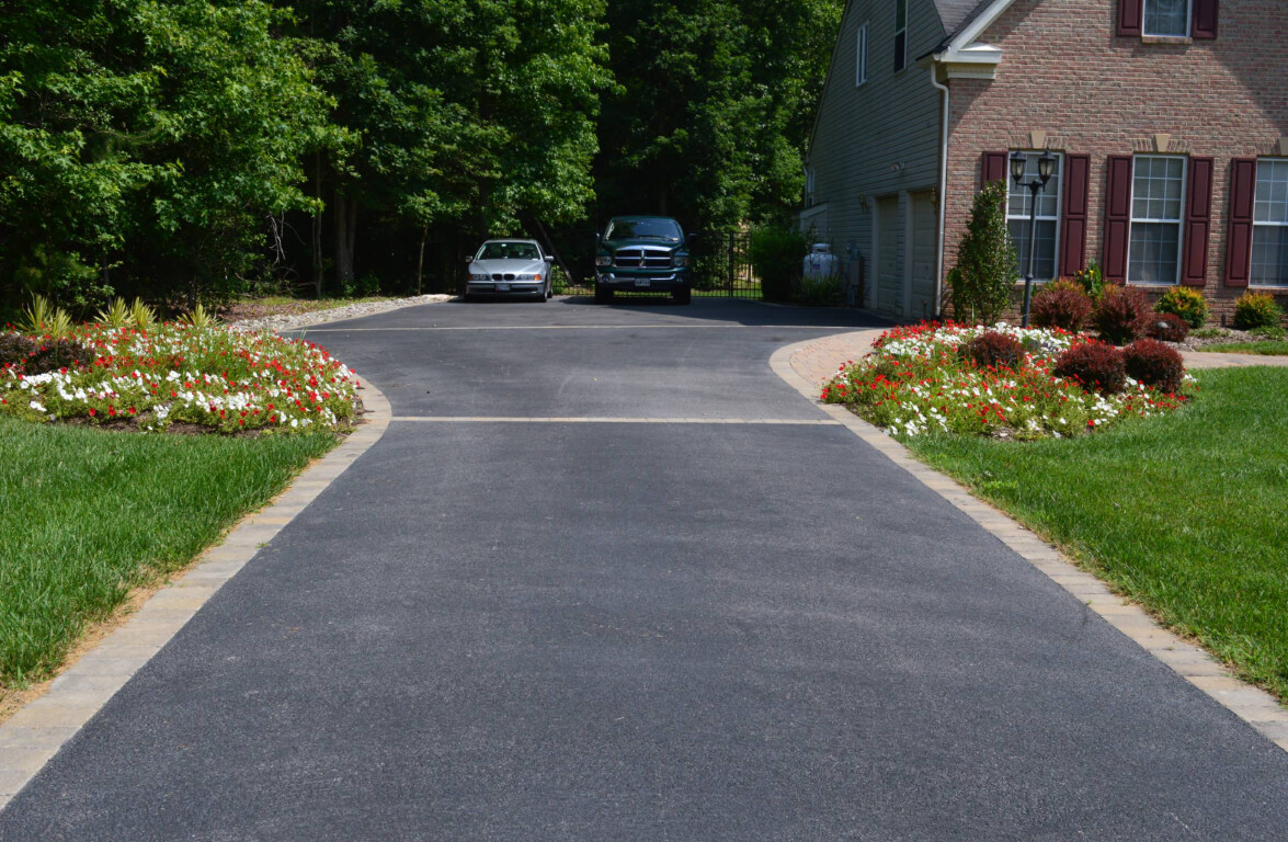 Newly installed curved concrete driveway with professional landscaping in Murrieta